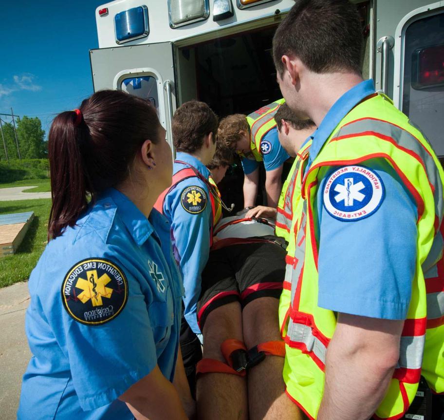 EMS students loading patient into ambulance