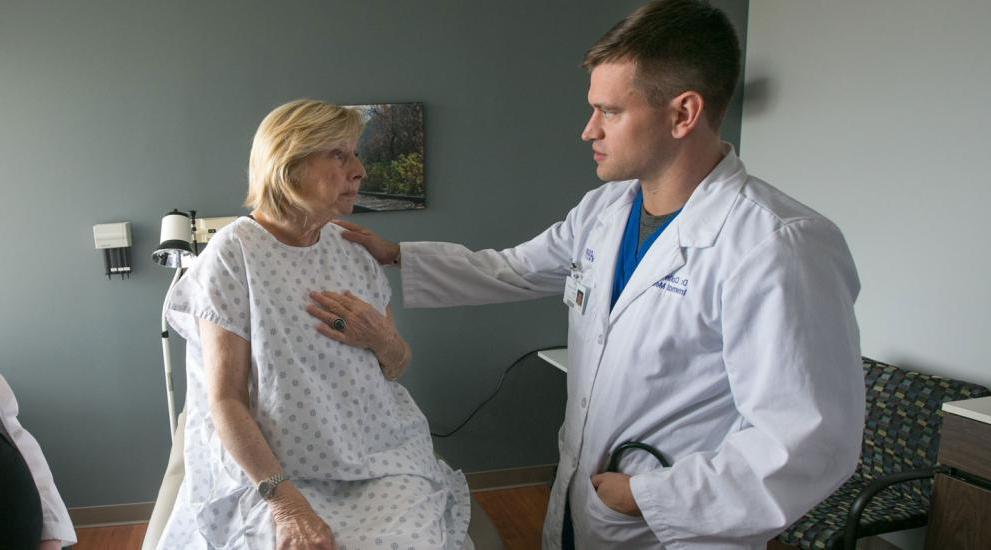 Doctor speaking with patient in examination room